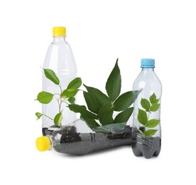 Photo of Recycling concept. Plastic bottles with plants isolated on white