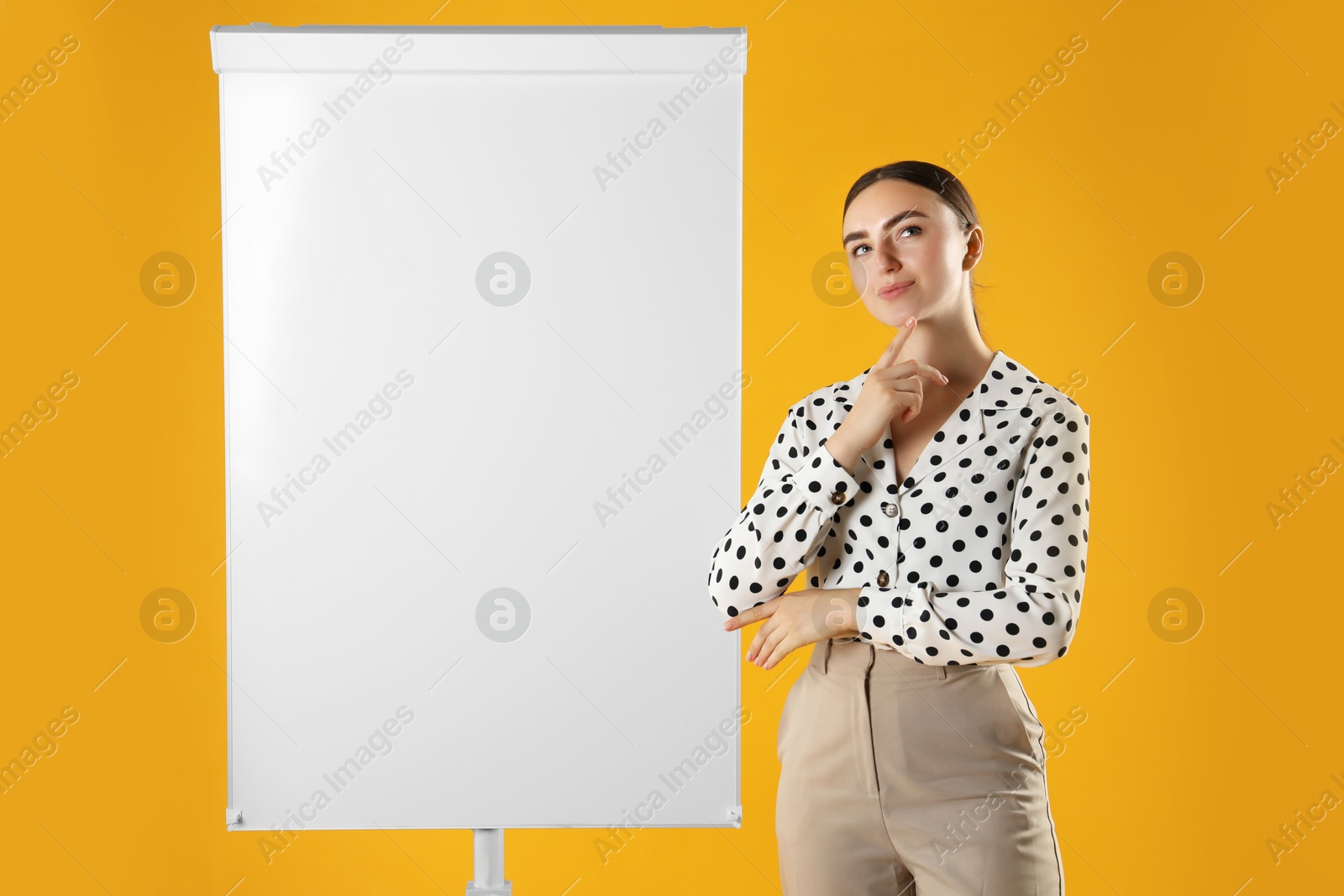 Photo of Woman near flip chart on orange background. Mockup for design