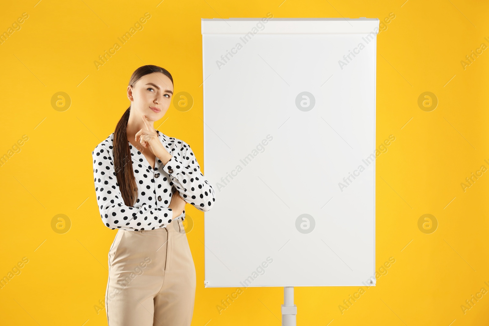 Photo of Woman near flip chart on orange background. Mockup for design