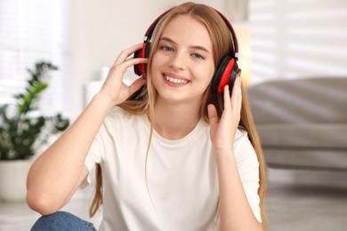 Photo of Portrait of teenage girl in headphones at home