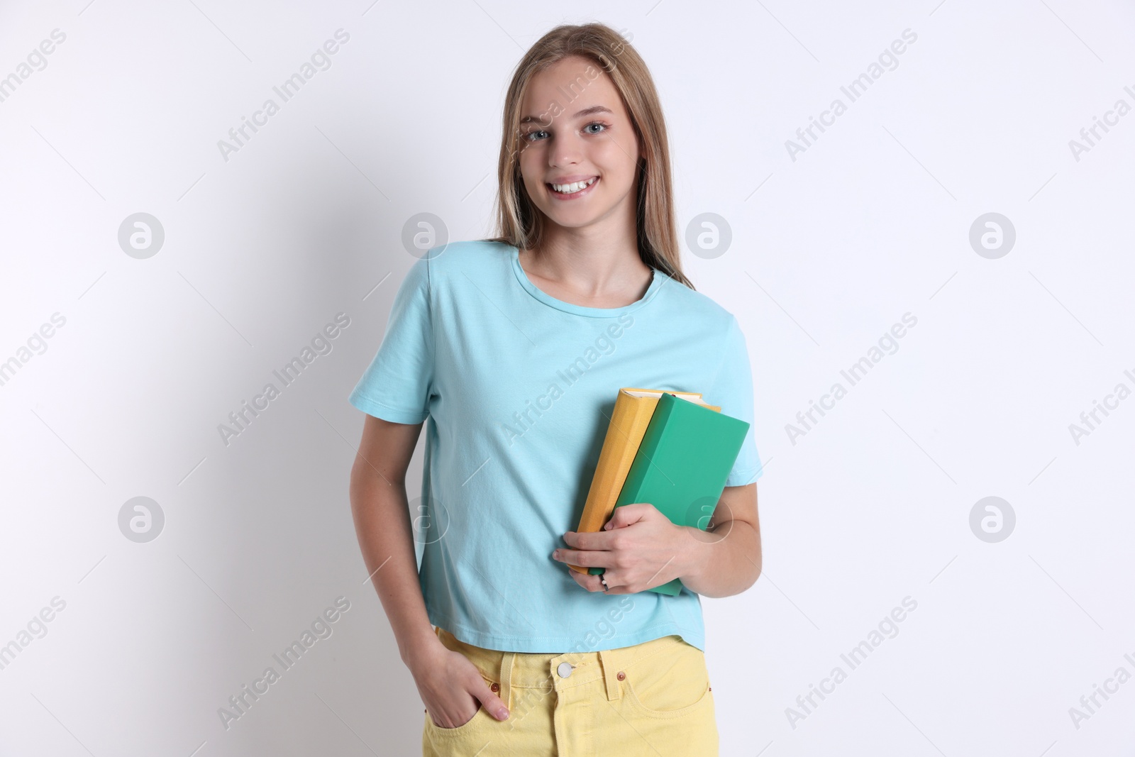 Photo of Teenage girl with books on white background