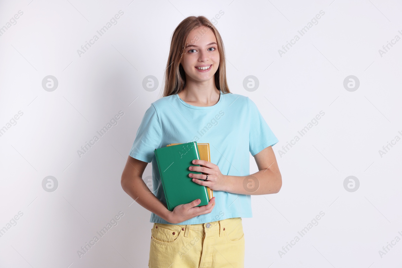 Photo of Teenage girl with books on white background