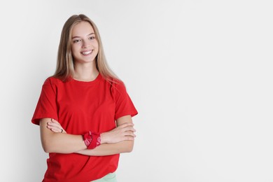 Portrait of teenage girl on white background, space for text