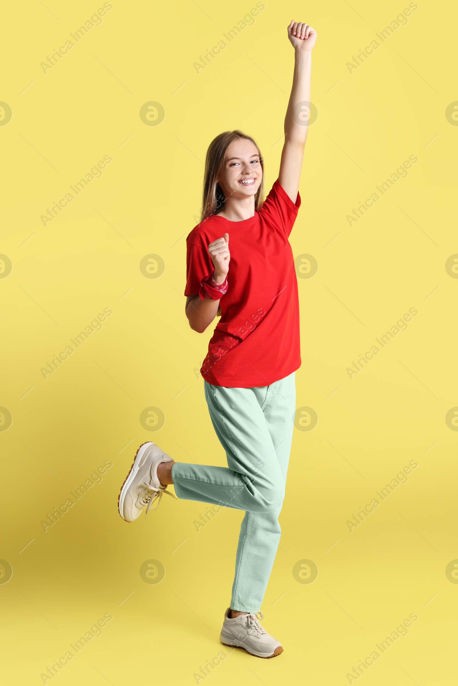 Photo of Full length portrait of teenage girl on yellow background