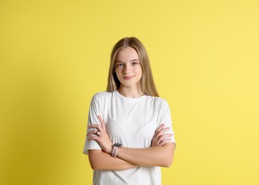 Photo of Portrait of teenage girl on yellow background