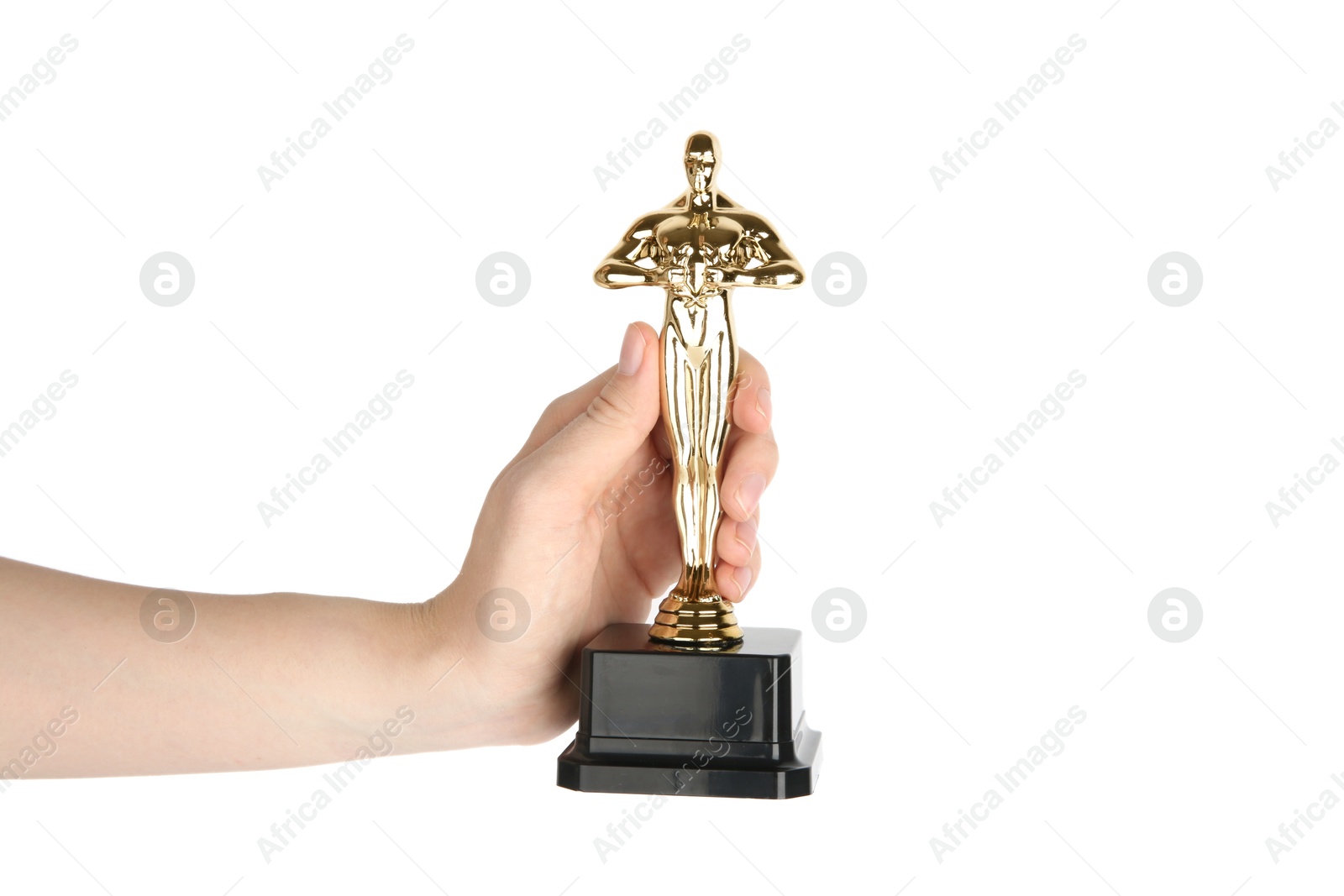 Photo of Woman holding	golden trophy in shape of human figure against white background, closeup