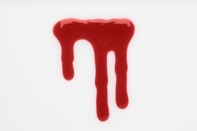 Photo of Stain of blood on white background, top view