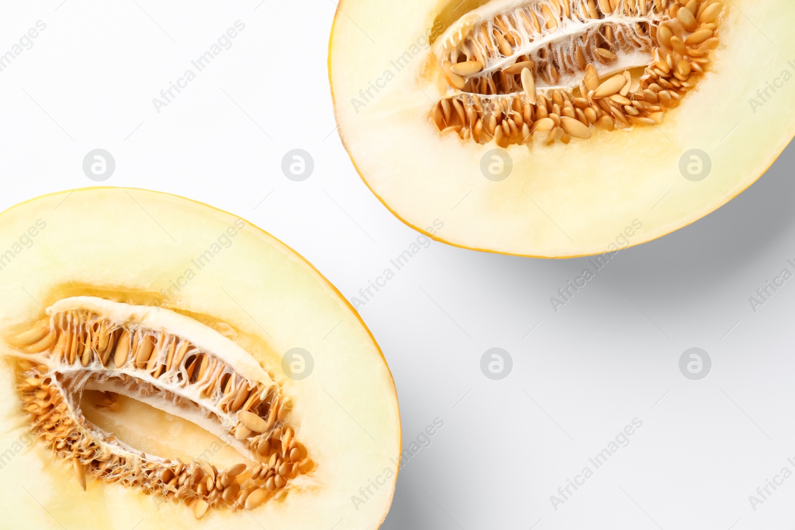 Photo of Halves of fresh melon on white background, top view