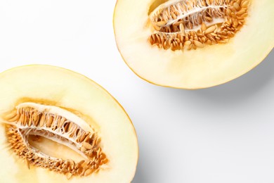 Halves of fresh melon on white background, top view