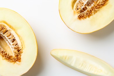 Photo of Fresh cut melons on white background, flat lay