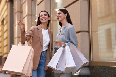 Happy women with colorful shopping bags outdoors