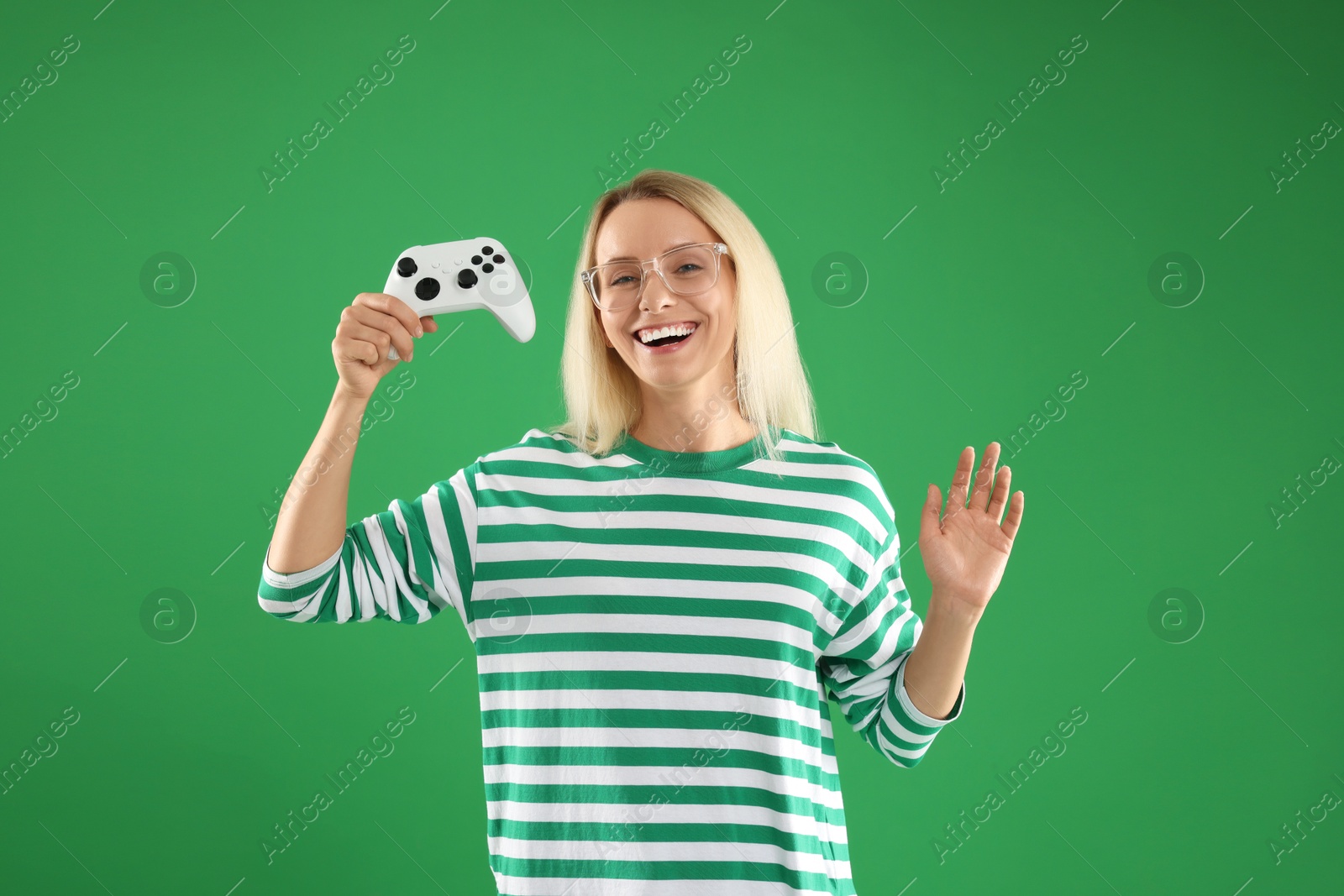 Photo of Happy woman with controller on green background