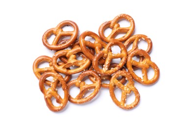 Photo of Many delicious pretzel crackers isolated on white, top view