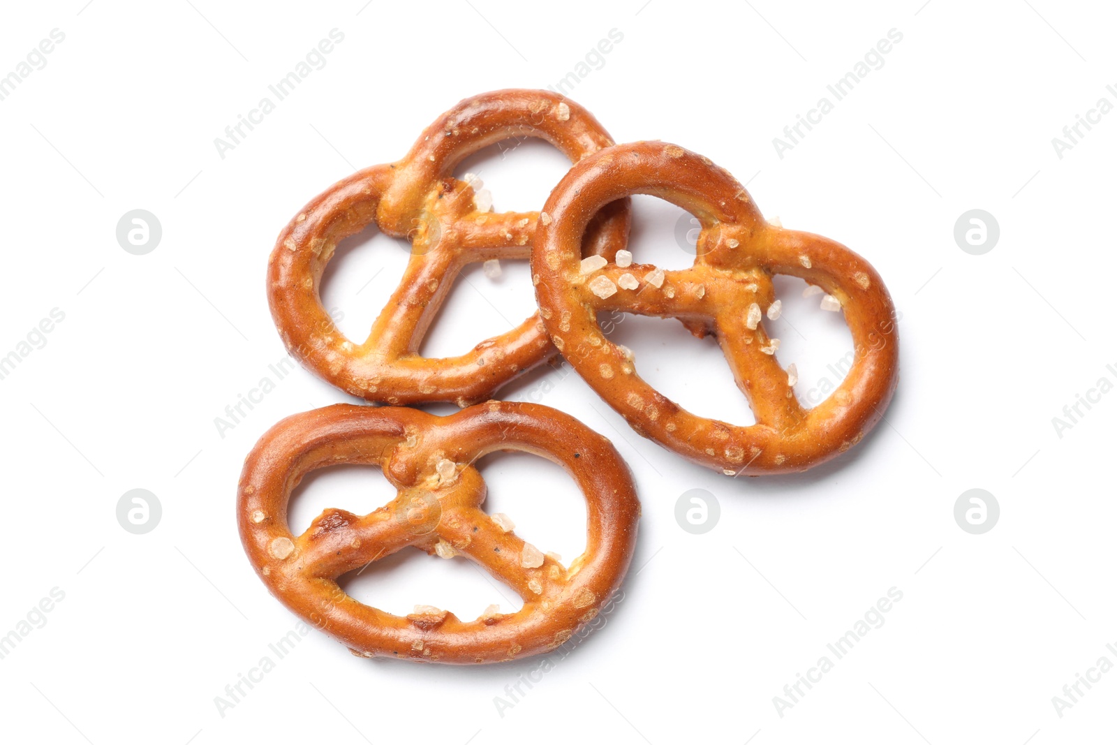 Photo of Many delicious pretzel crackers isolated on white, top view