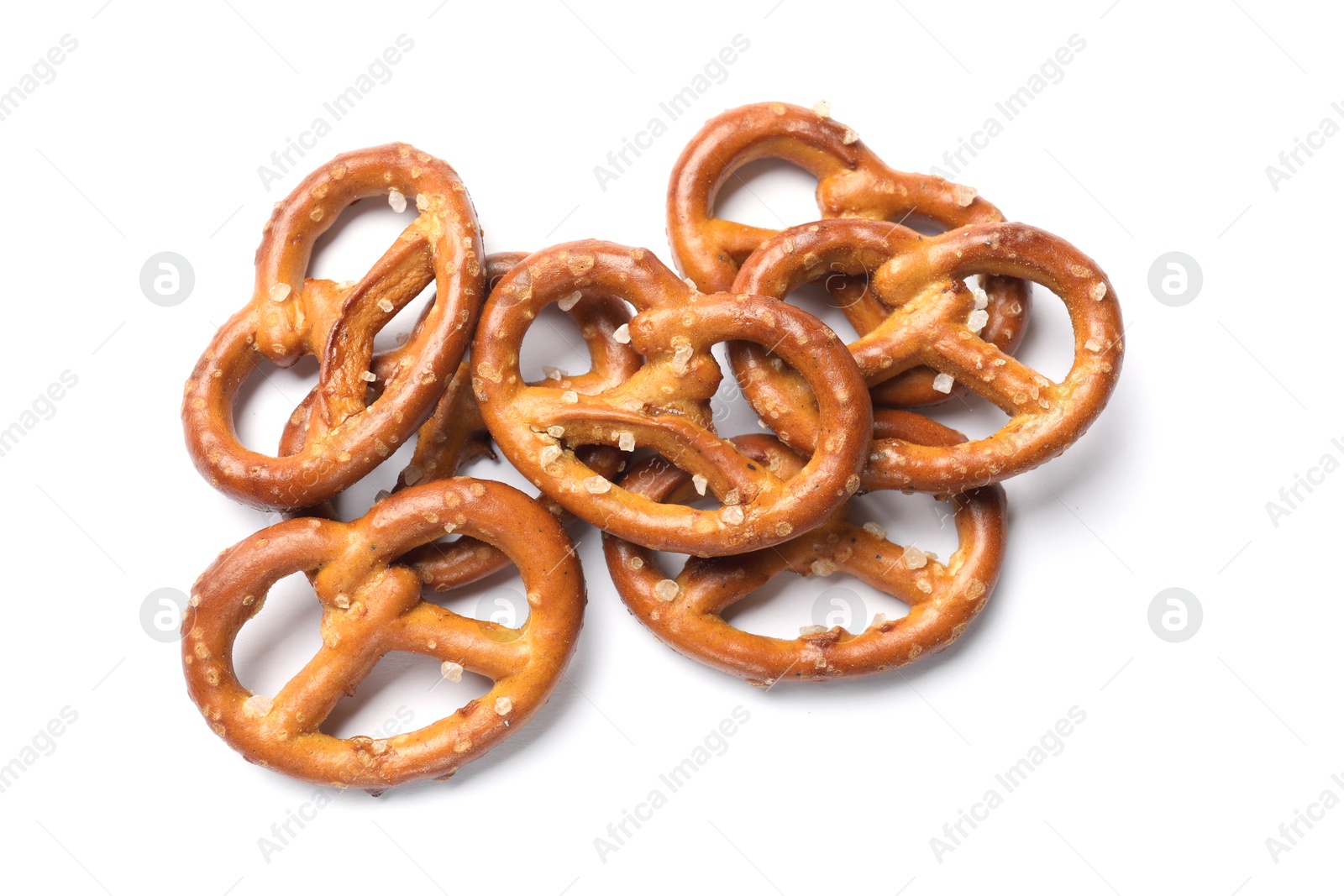 Photo of Many delicious pretzel crackers isolated on white, top view