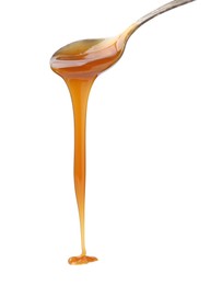 Photo of Tasty caramel sauce dripping from spoon on white background, closeup