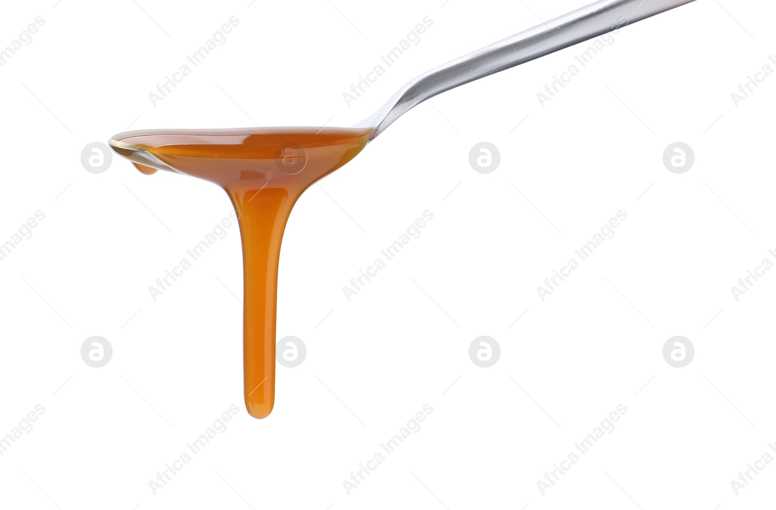 Photo of Tasty caramel sauce dripping from spoon on white background, closeup