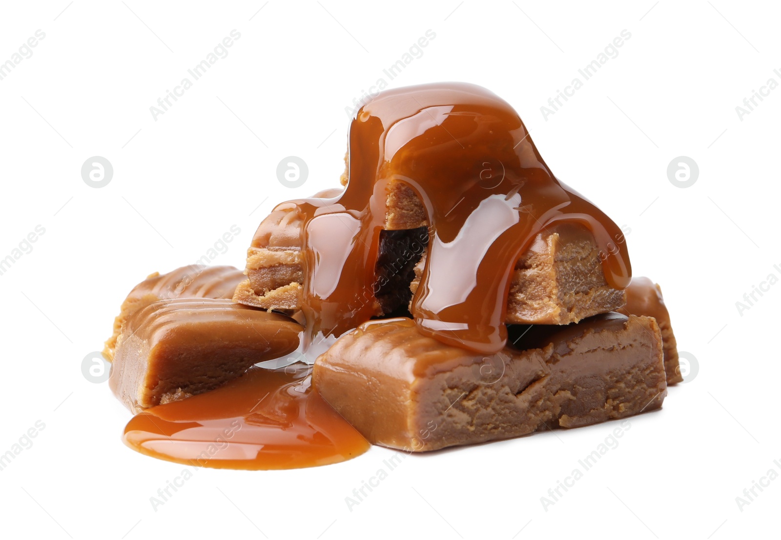 Photo of Tasty candies with caramel sauce isolated on white