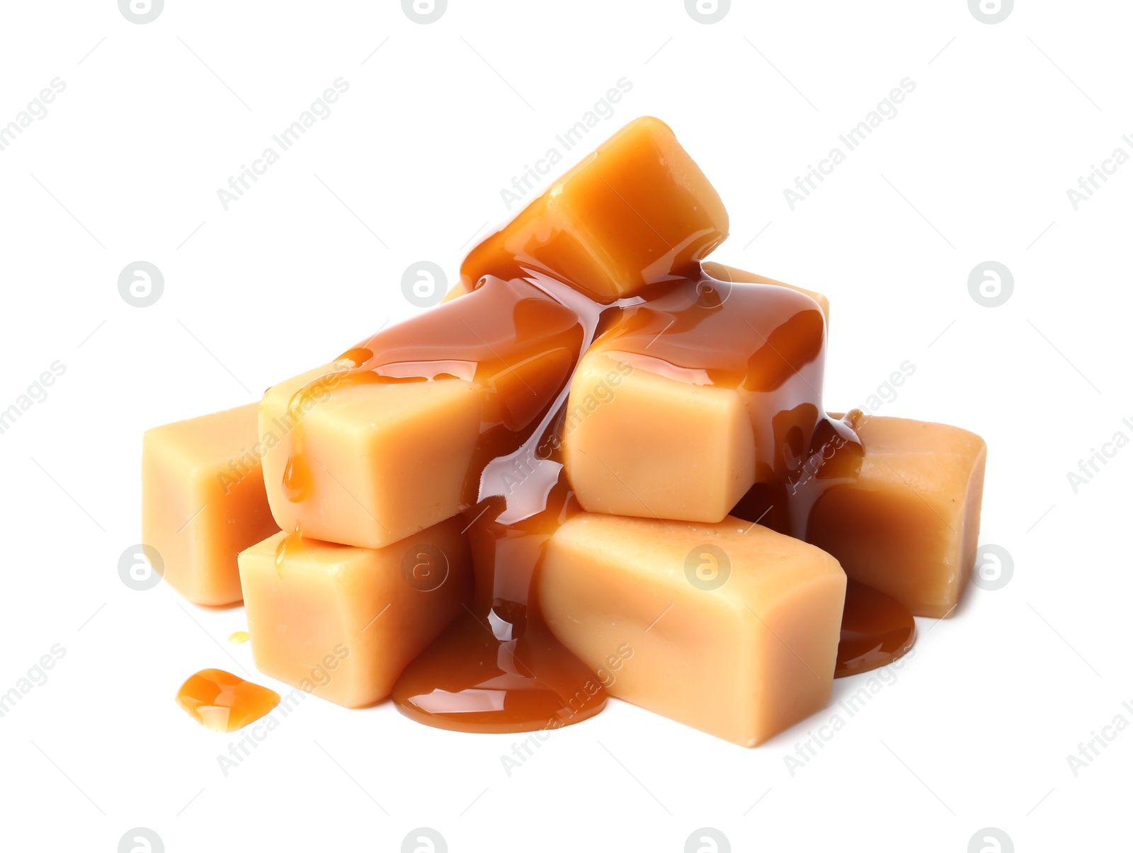 Photo of Tasty candies with caramel sauce isolated on white