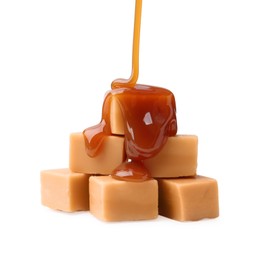 Photo of Caramel sauce dripping onto candies on white background, closeup