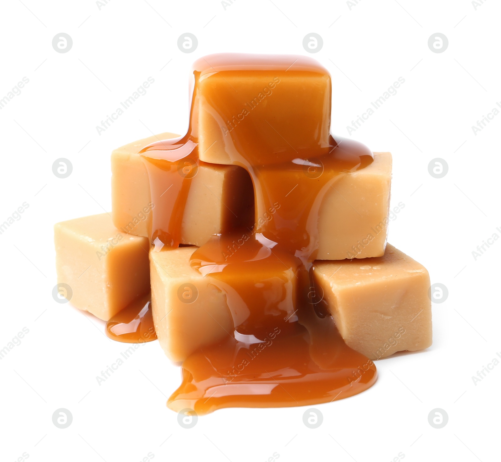 Photo of Tasty candies with caramel sauce isolated on white