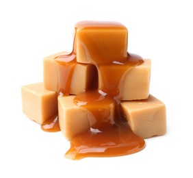 Photo of Tasty candies with caramel sauce isolated on white