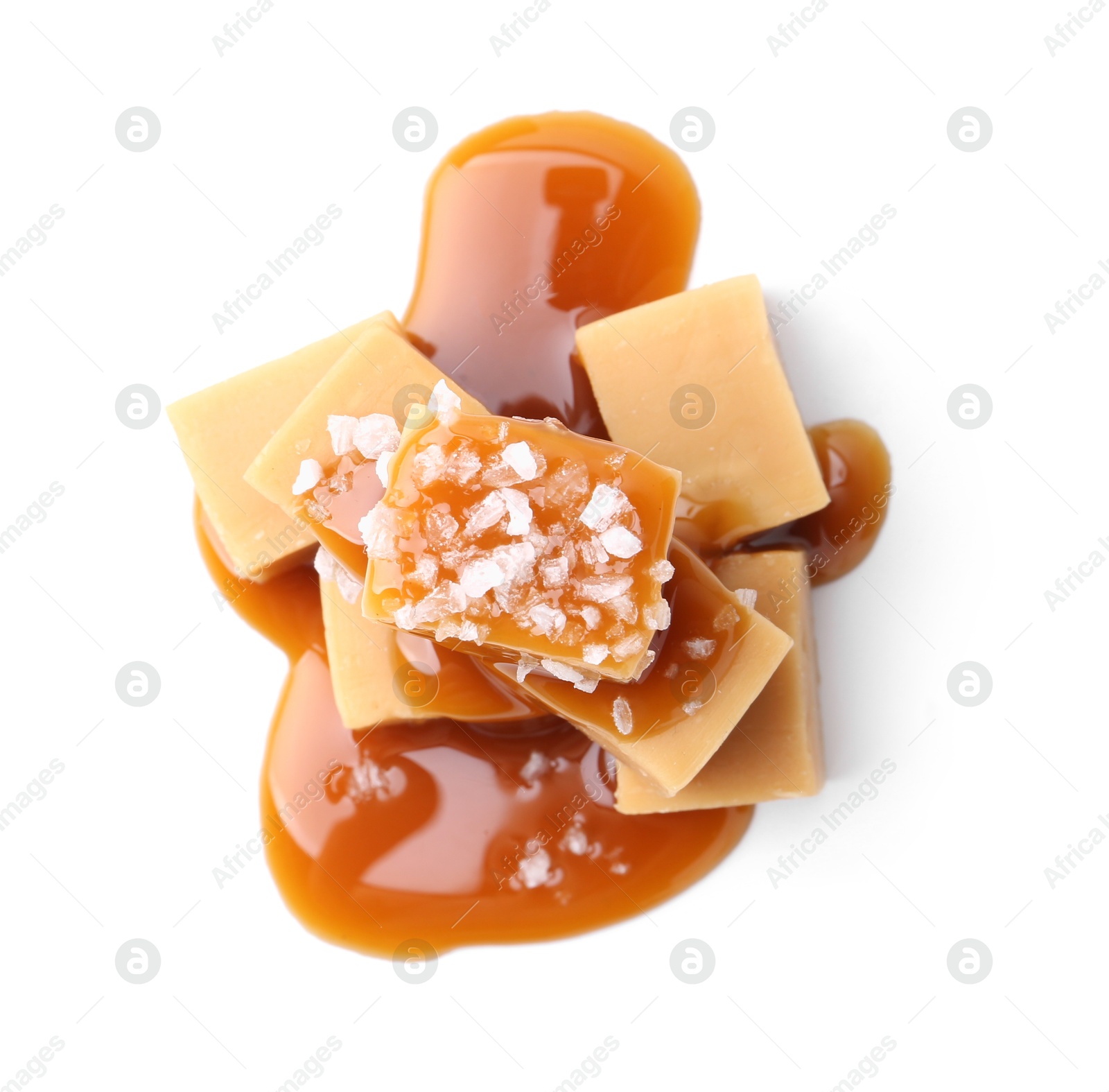 Photo of Tasty candies with salted caramel isolated on white, top view