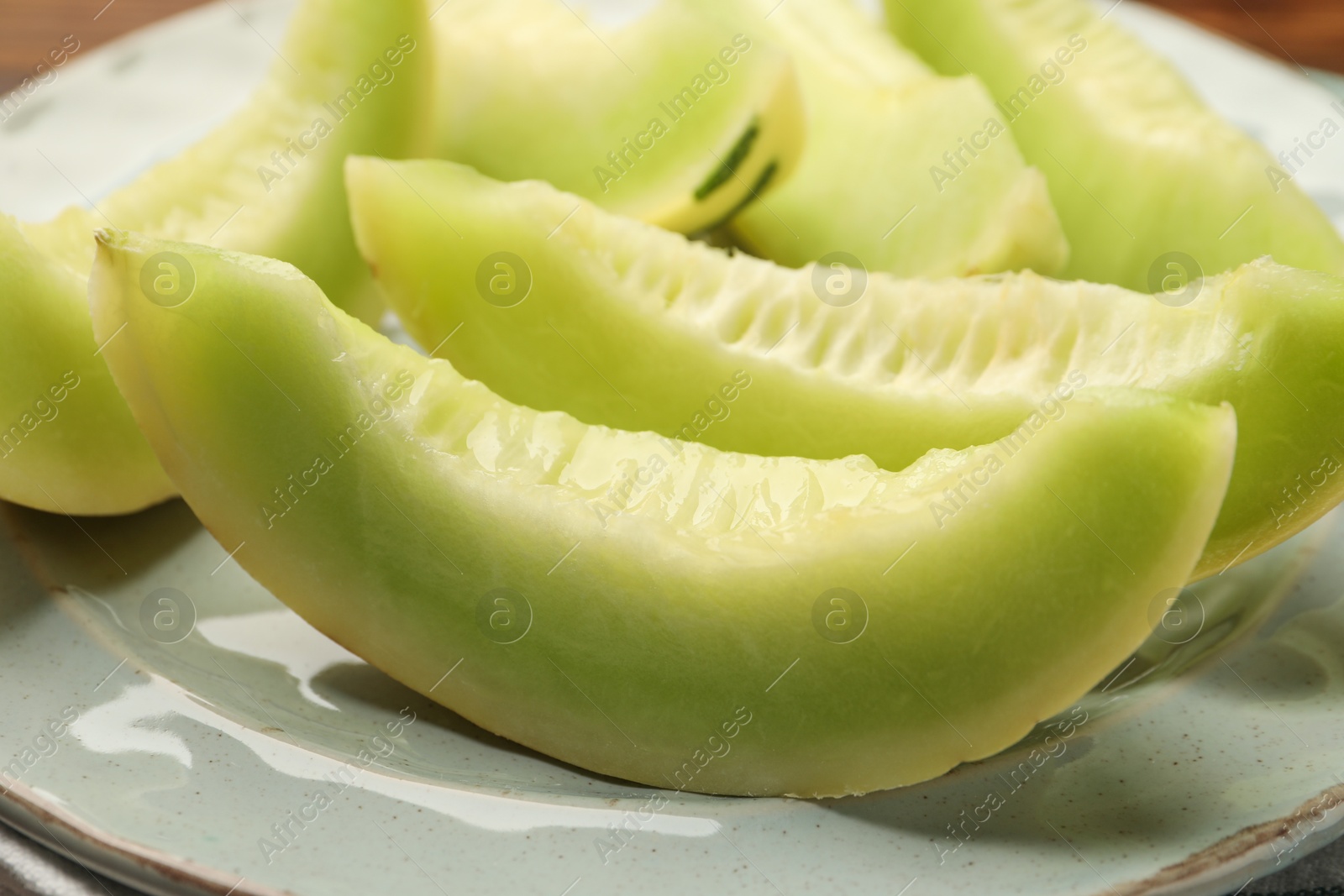 Photo of Pieces of honeydew melon on plate, closeup