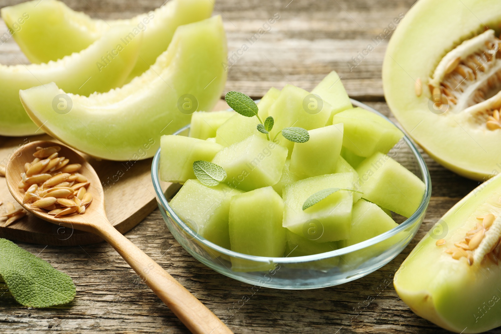 Photo of Slices of yummy melon on wooden table, closeup