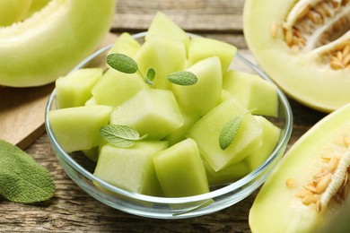 Photo of Slices of yummy melon on wooden table, closeup