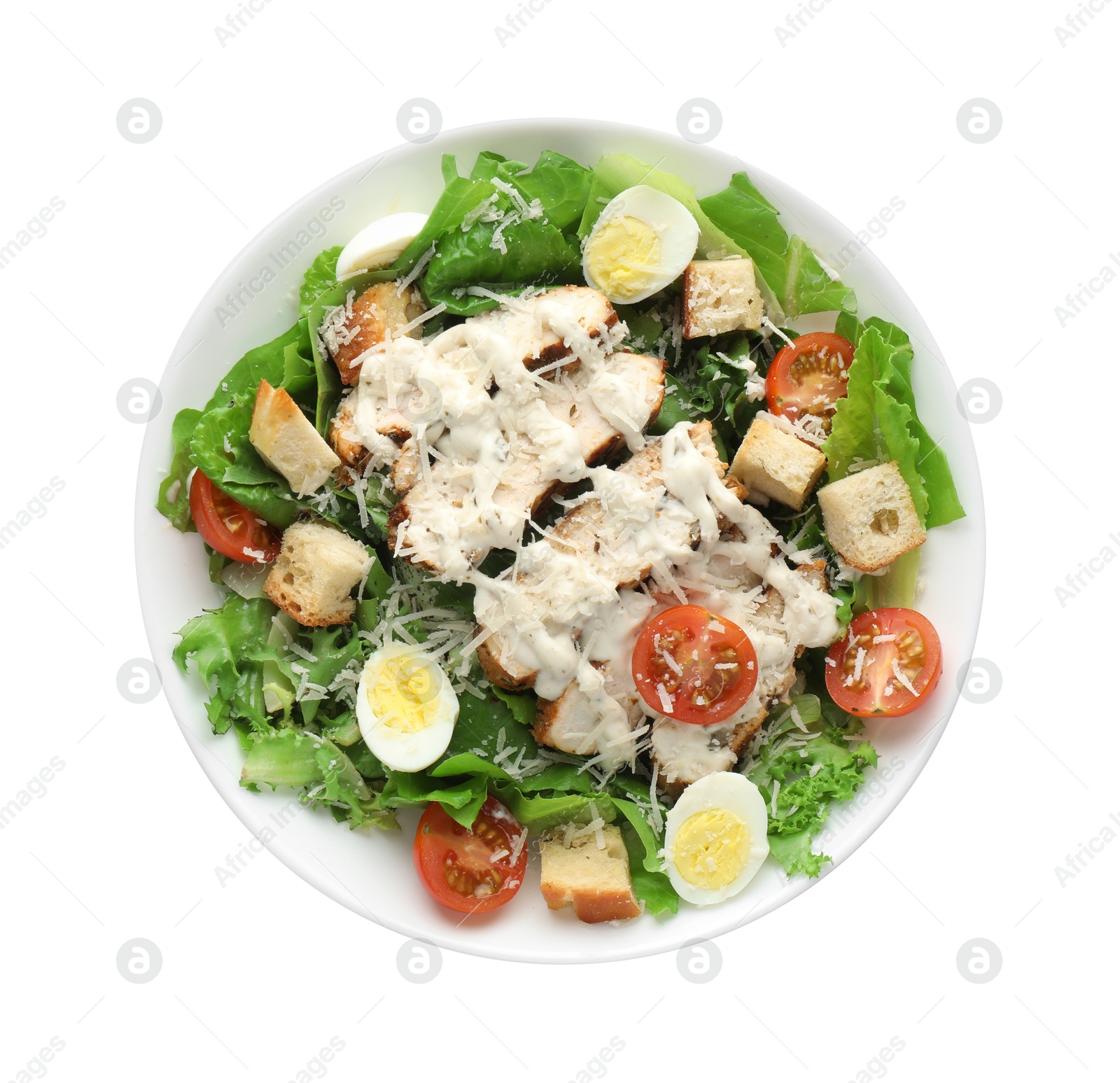 Photo of Tasty Caesar salad with chicken and tomatoes in bowl isolated on white, top view