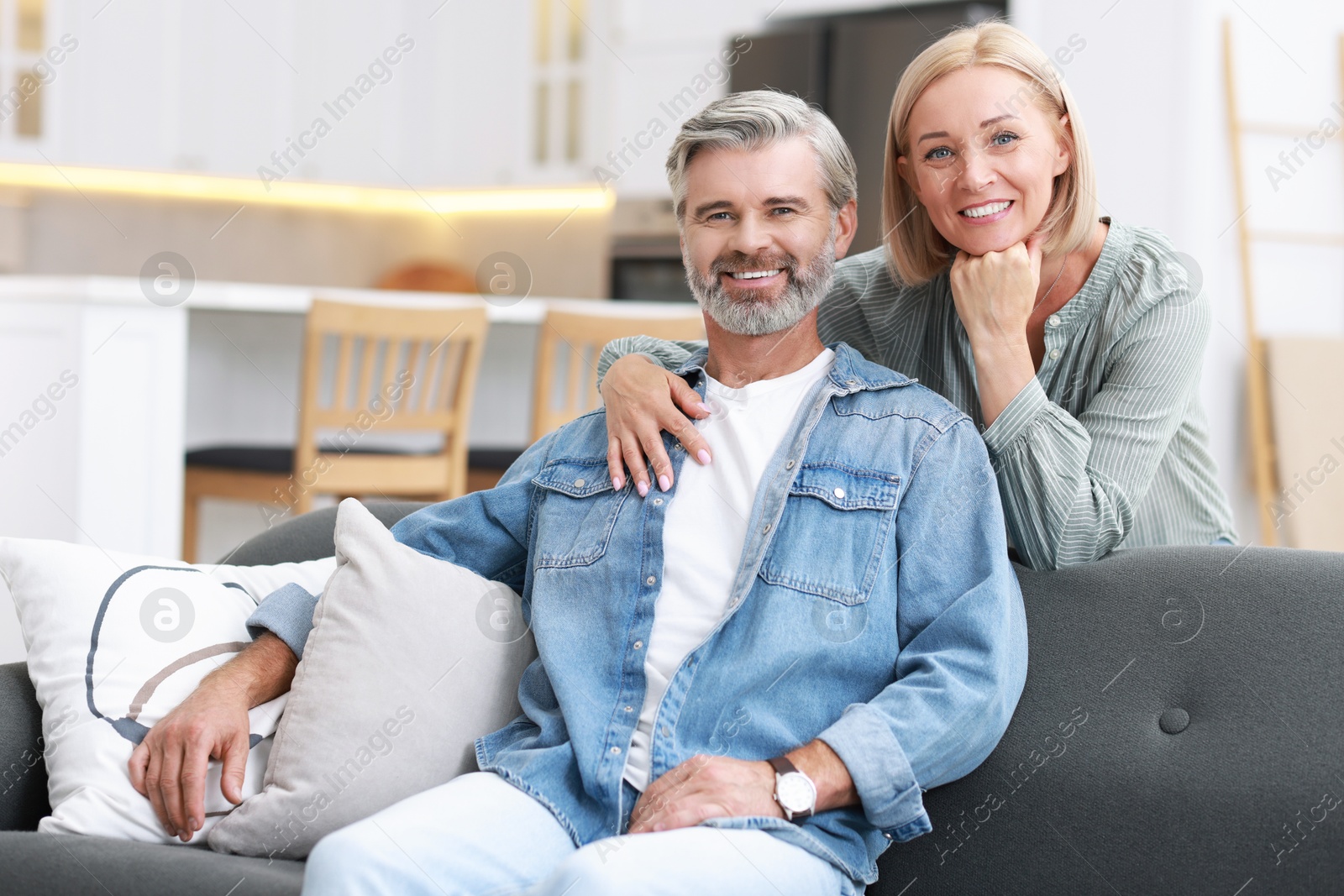 Photo of Portrait of happy middle aged couple in kitchen