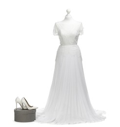 Photo of Mannequin with beautiful wedding dress and shoes isolated on white