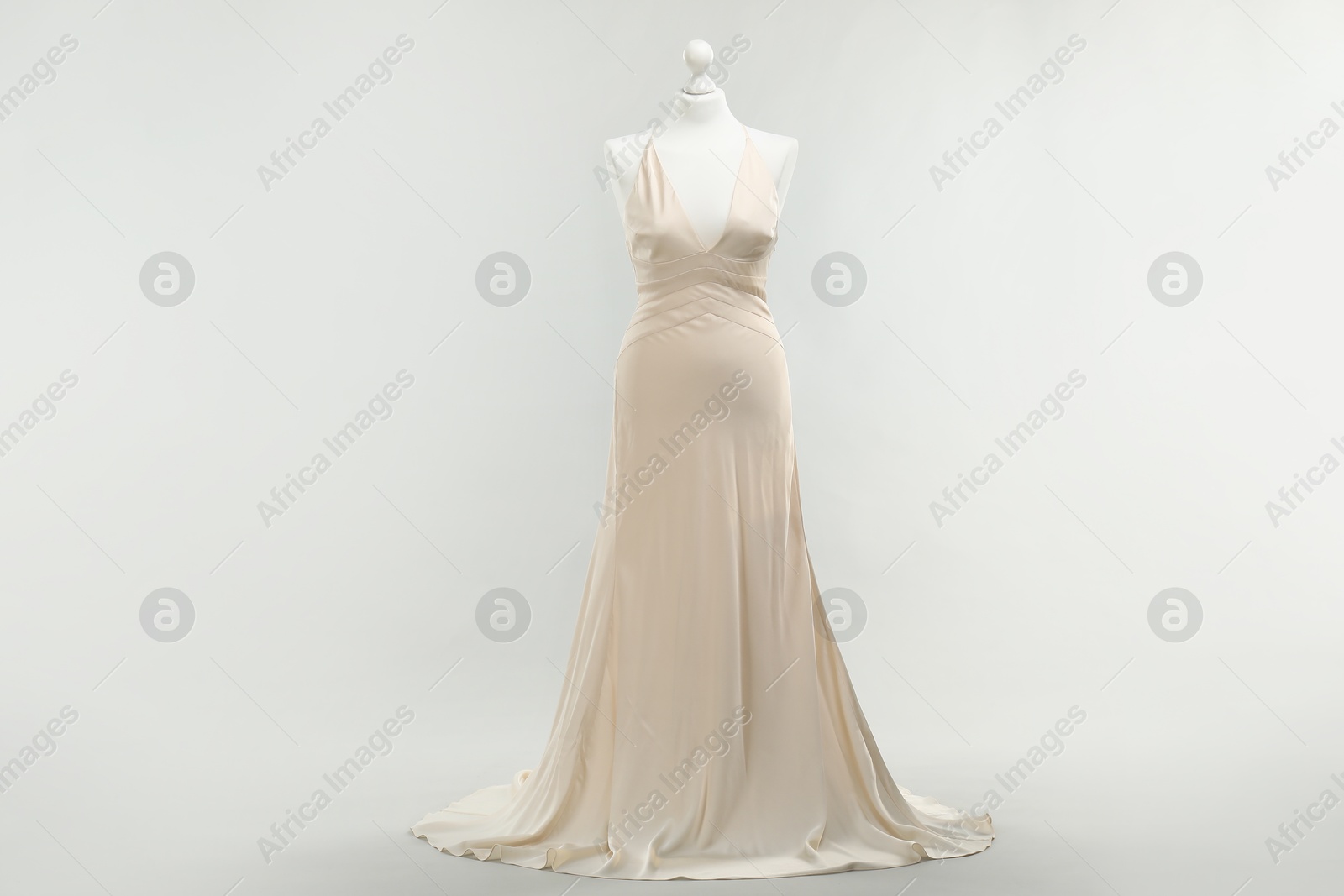 Photo of Mannequin with beautiful wedding dress on light grey background