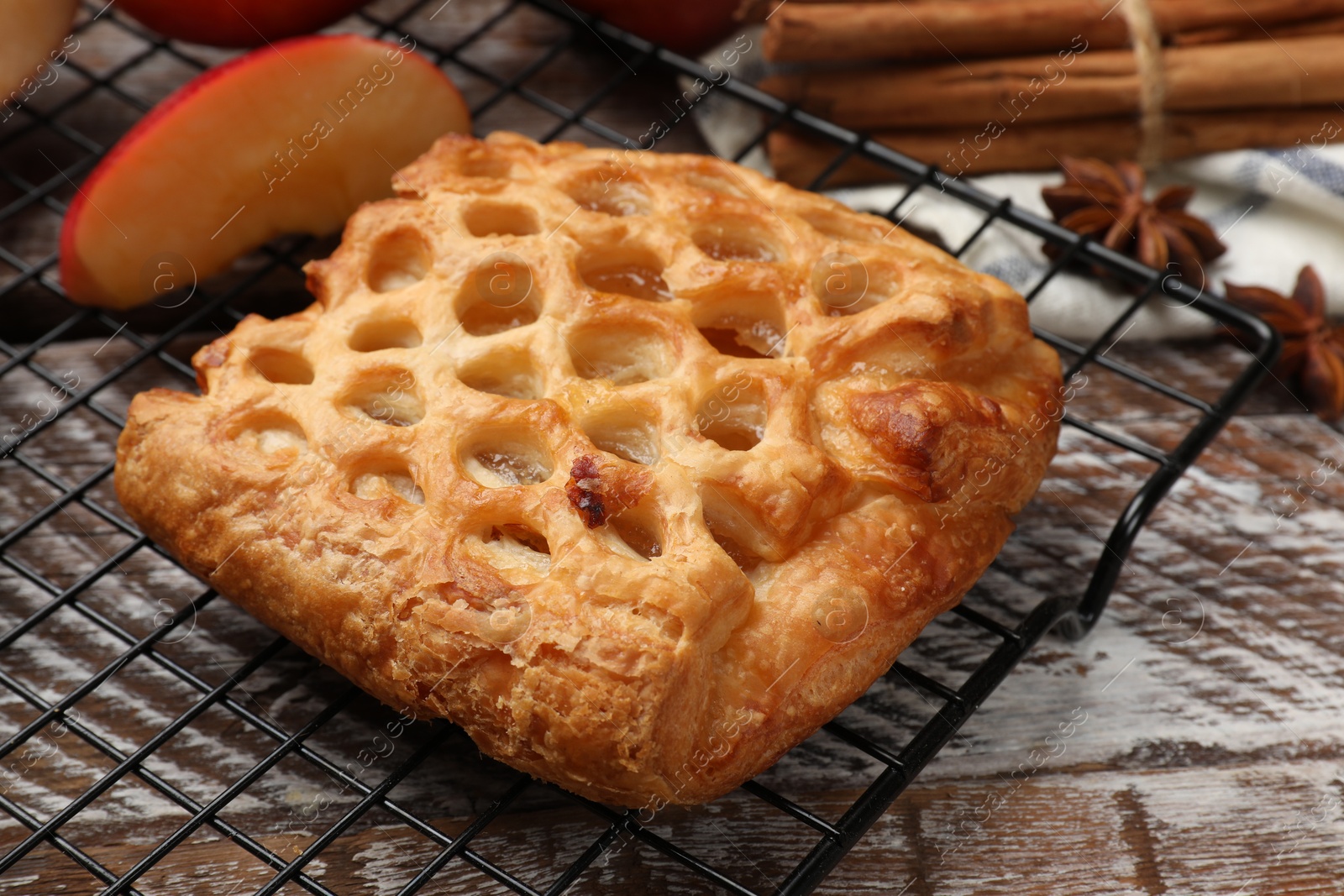 Photo of Delicious puff pastry with fruit filling on wooden table, closeup