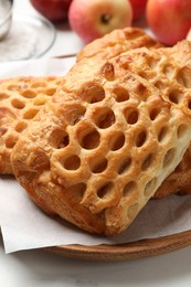 Delicious puff pastries with fruit filling on table, closeup