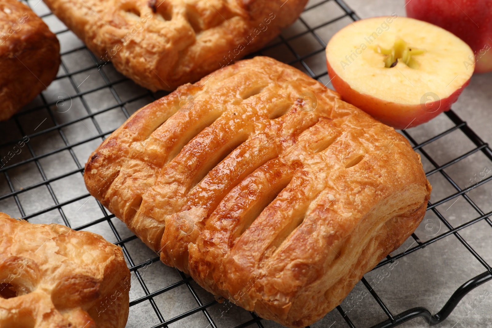 Photo of Delicious puff pastries with fruit filling on grey table, closeup