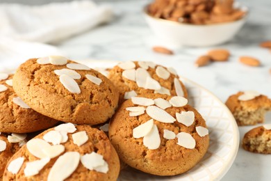 Photo of Tasty cookies with almond flakes on table, closeup