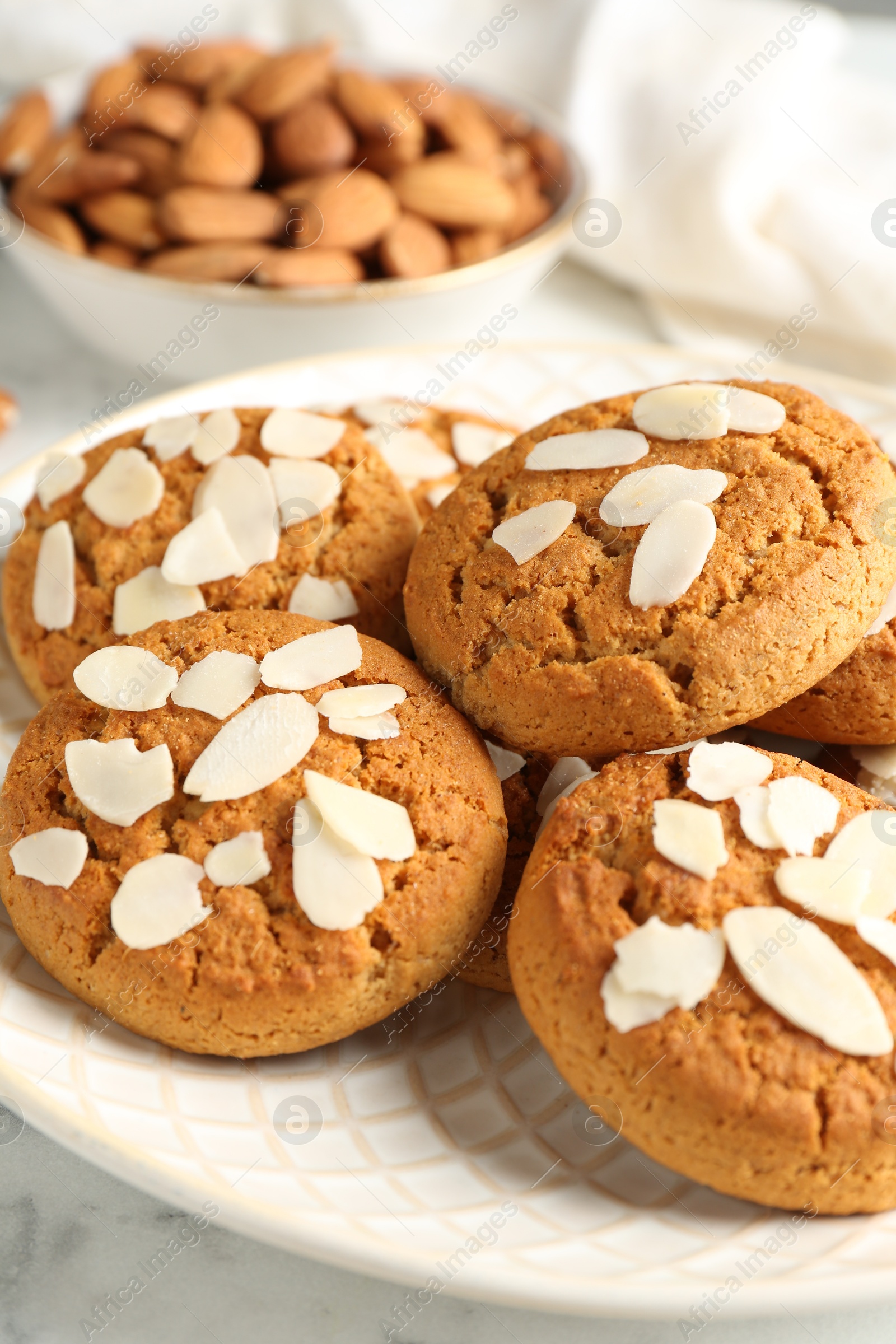 Photo of Tasty cookies with almond flakes on table, closeup