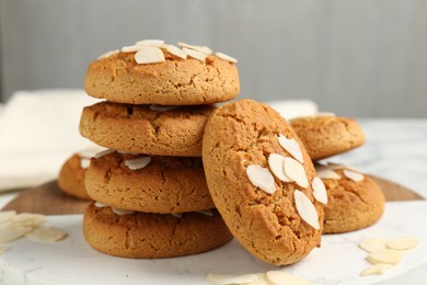 Photo of Tasty cookies with almond flakes on table, closeup