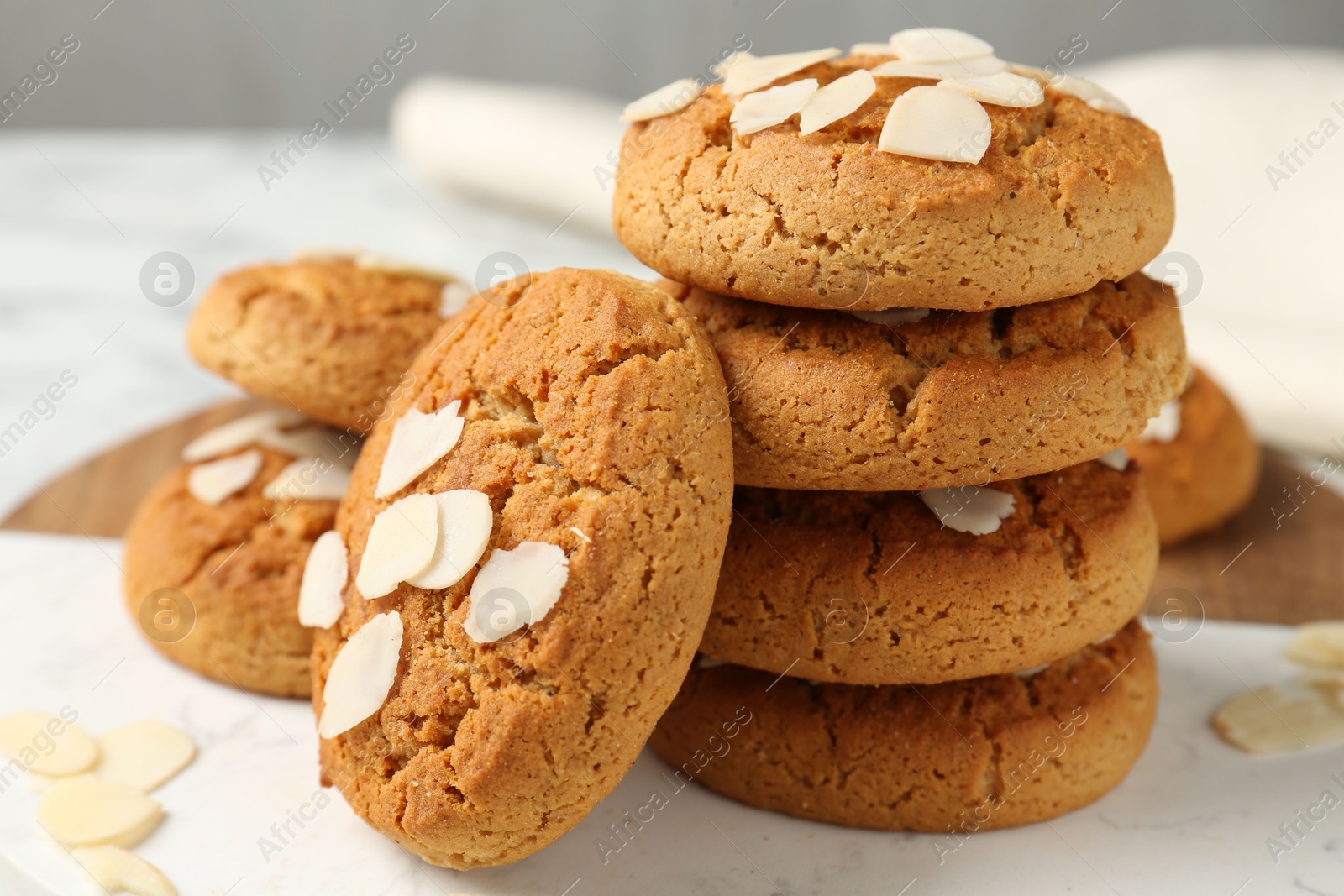 Photo of Tasty cookies with almond flakes on table, closeup