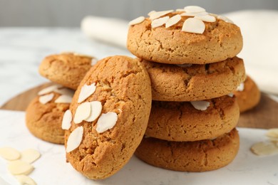 Photo of Tasty cookies with almond flakes on table, closeup