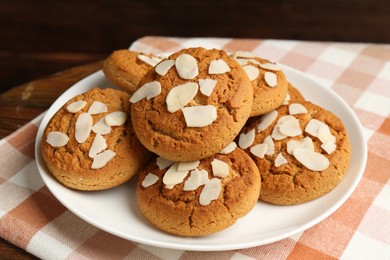 Photo of Tasty cookies with almond flakes on table, closeup