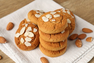 Photo of Tasty cookies with almond flakes and nuts on table, closeup