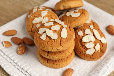 Photo of Tasty cookies with almond flakes and nuts on table, closeup