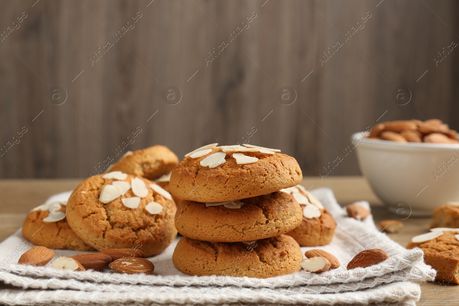 Photo of Tasty cookies with almond flakes and nuts on table, closeup