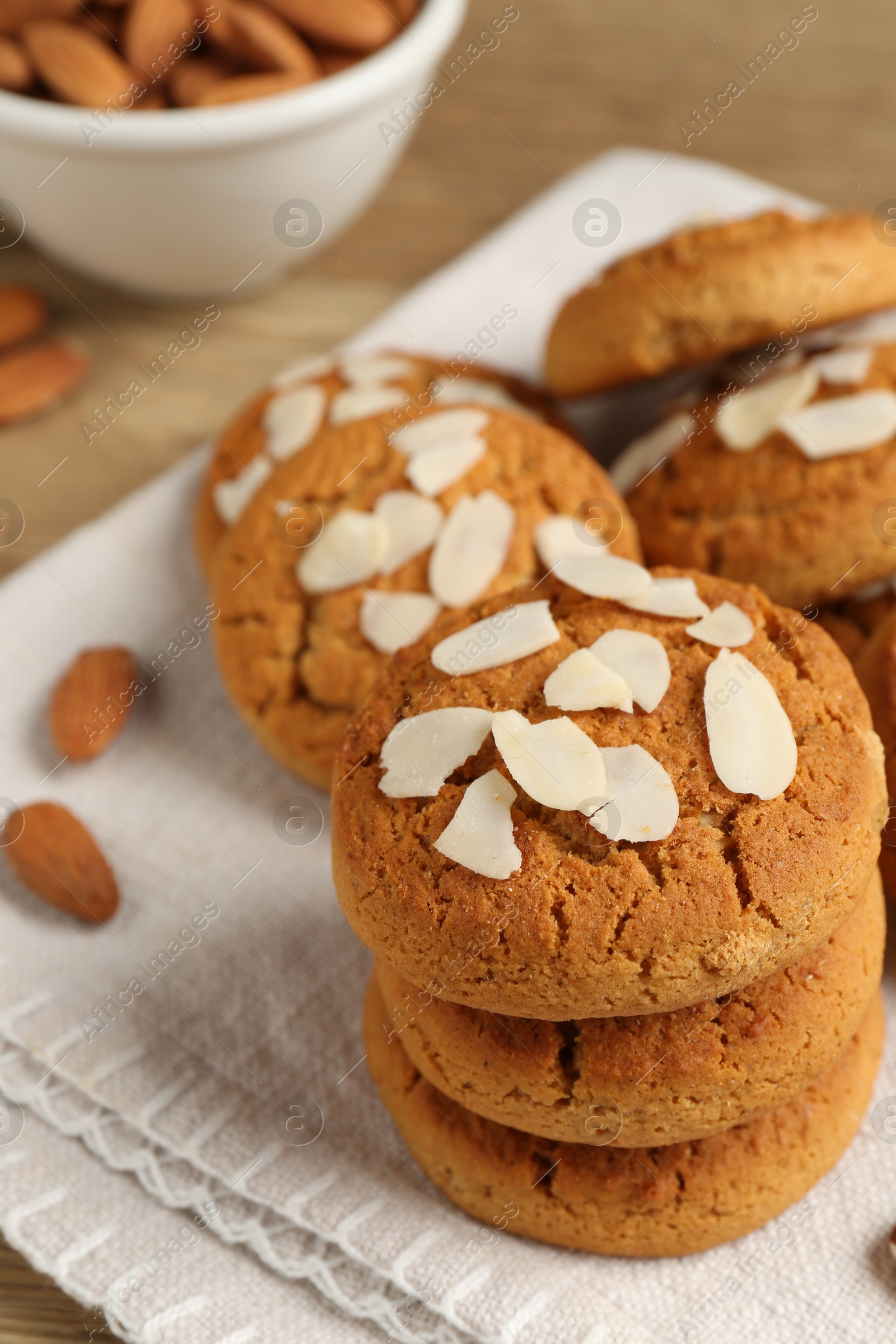 Photo of Tasty cookies with almond flakes and nuts on table, closeup