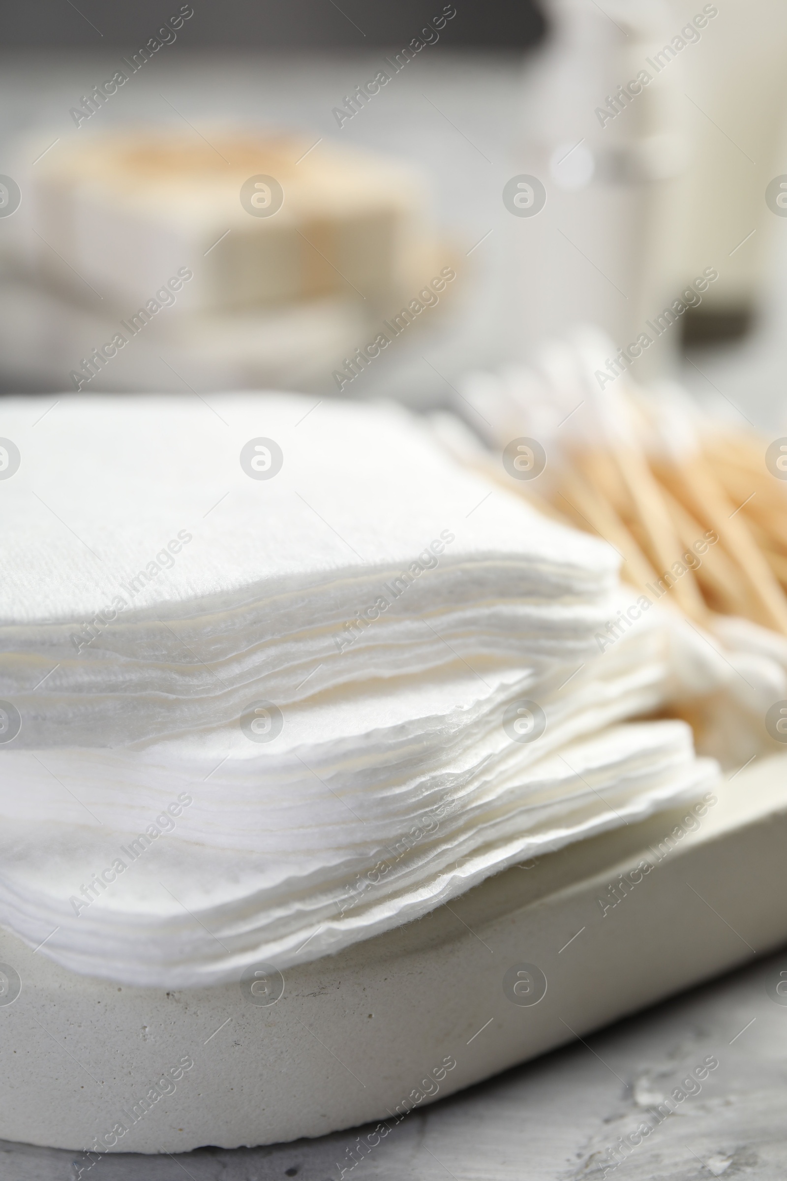 Photo of Clean cotton pads on grey table, closeup