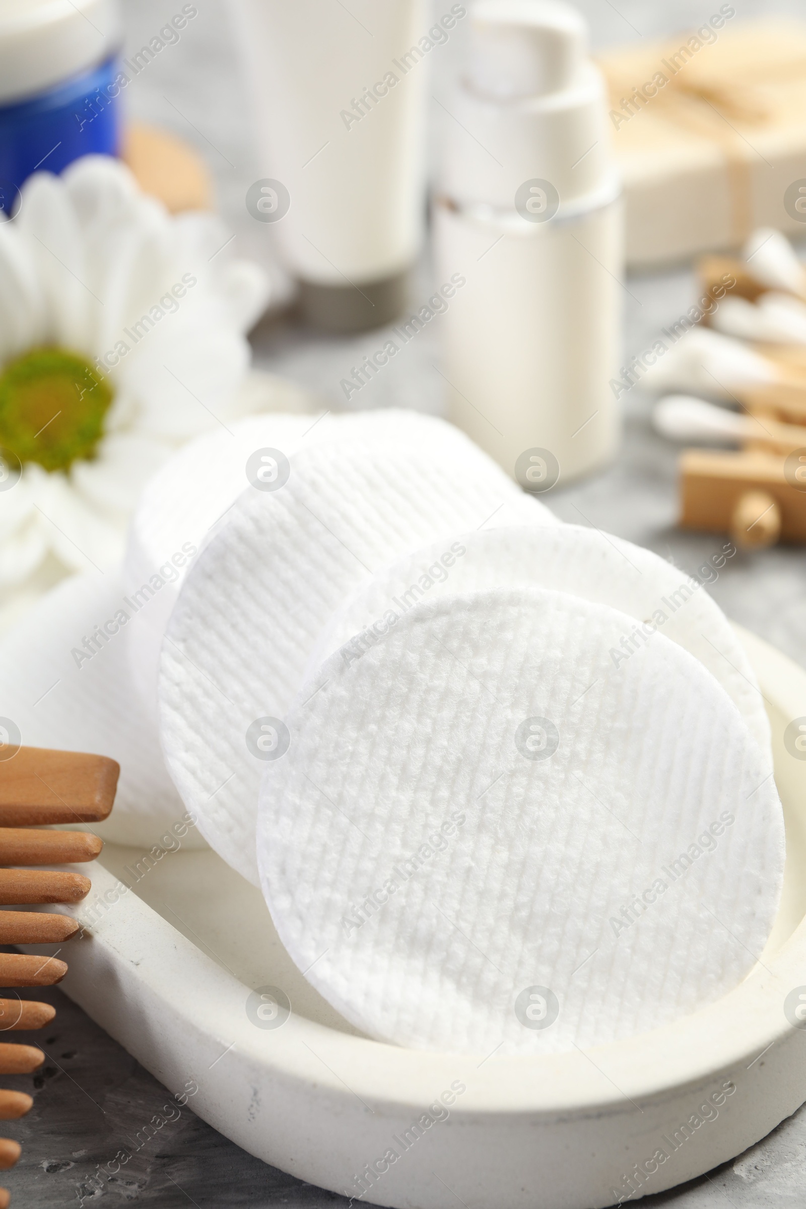 Photo of Clean cotton pads on grey table, closeup