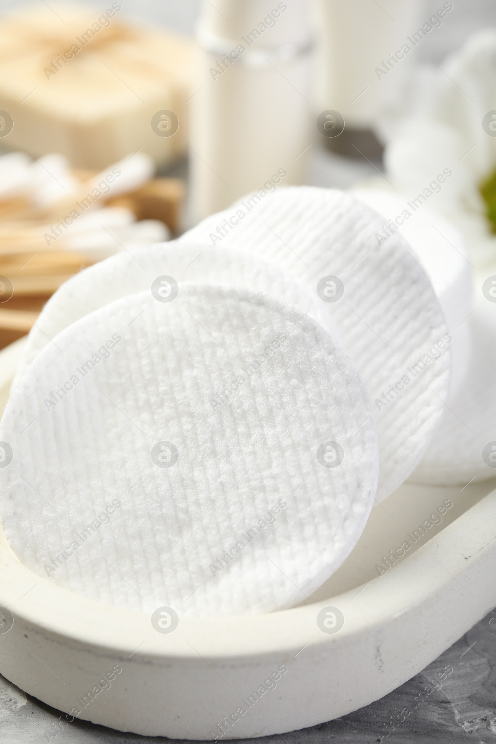 Photo of Clean cotton pads on grey table, closeup